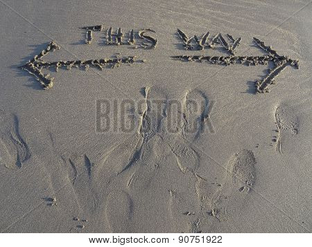 This Way Sand Writing And Footprints Upon Beach