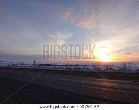Yellow sunset with blue stains on the sky