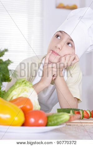 Smiling kitchen boy holding