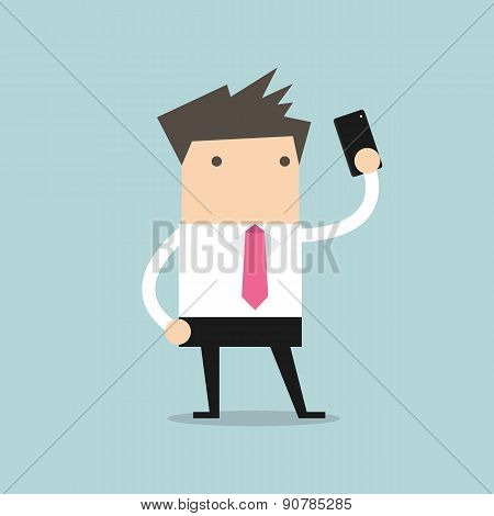 Businessman taking selfie using a mobile phone