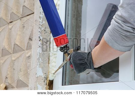 Worker's Hand Fix A Window By  Polyurethane Foam