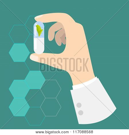 Hand of a doctor holding drug capsule.