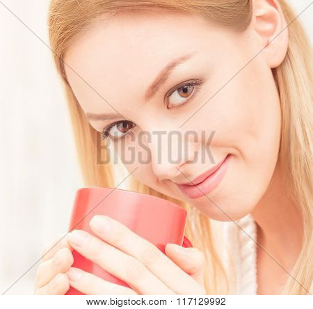 Lady with a cup of tea indoors