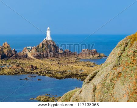 La Corbiere Lighthouse On The Rocky Coast Of Jersey Island