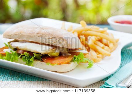 Vegetarian Ciabatta with tomatoes, grilled cheese haloumi, avocado and lettuce with french fries on