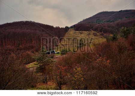 Autumn Landscape - Woods On The Hillsides. Ski Slope With Cableway In Fall. Mountain Village Podhrad