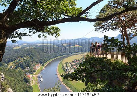 People On Bastei Rocks Looking At Panorama With River Elbe And Rathen, Saxon Switzerland