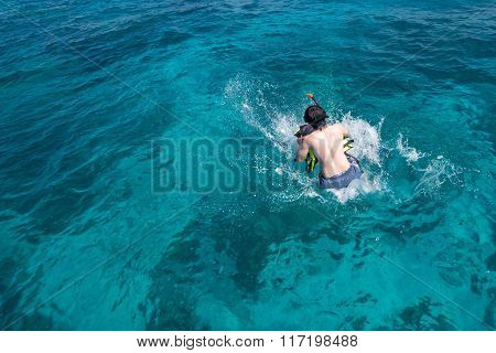 Man jumping from speedboat to the sea at Tachai island, Thailand