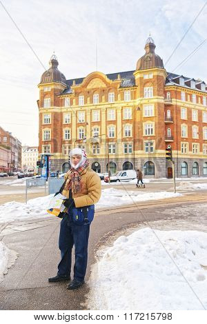 Man Holding Map In Kopenhagen City Center In Winter