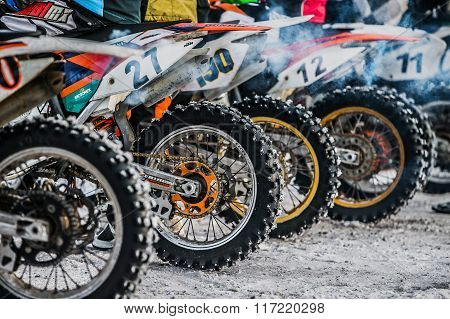 closeup of wheels of motorbikes standing at starting line