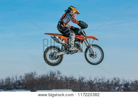 high flying motorcycle racer on blue sky background
