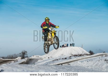 flight of motorcycle racer on a background of blue sky after jump