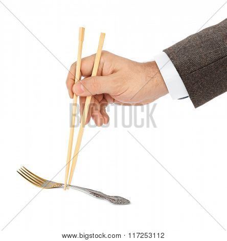 Hand with chopsticks and fork isolated on white background