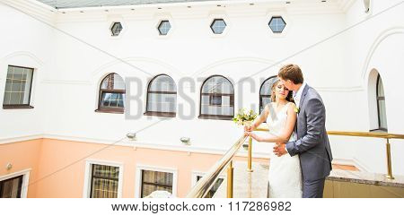Just married couple embraced.