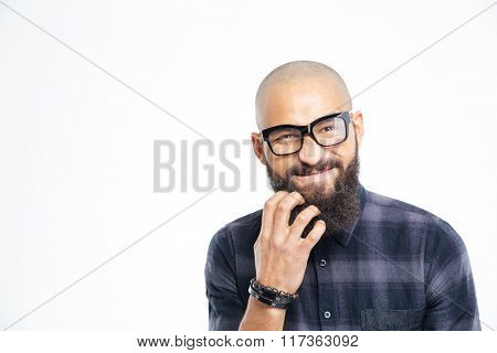 Closeup of handsome baldheaded young african american man in glasses scratching his beard