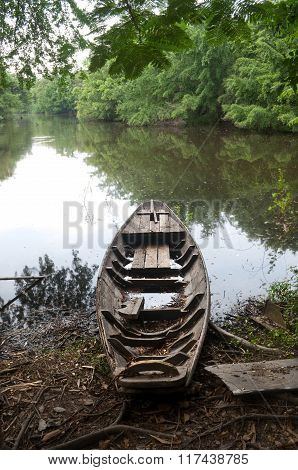 An Old Boat On A Lake Shore