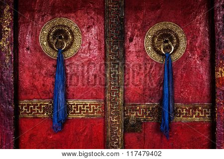 Gate of Spituk Gompa (Tibetan Buddhist monastery) with ornamented decorated door handles. Ladakh, India
