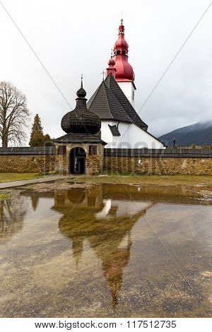 Cristian Kostol sv. Ladislava in Slovakia. Reflection in water