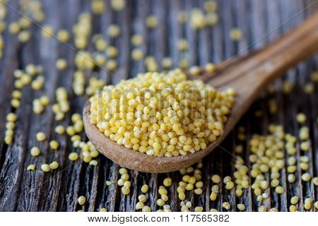 Millet on wooden spoon