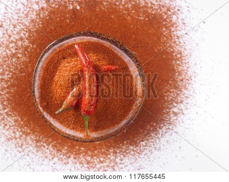 glass bowl of chili powder with chili padi