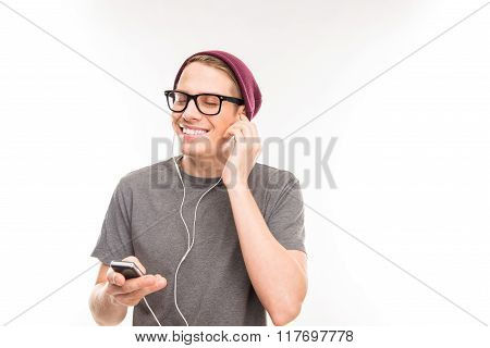 Portrait Of A Happy Man With Glasses And Hat Litening To Music