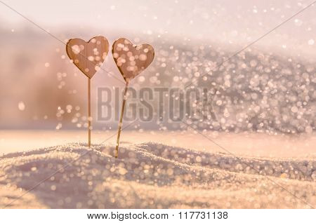 Two wooden hearts in snow