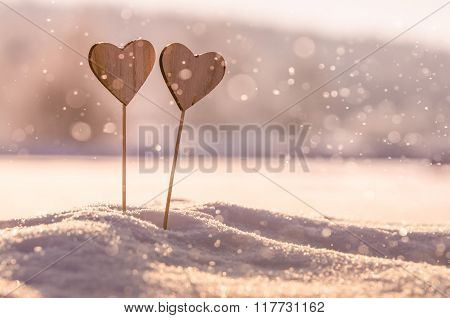 Two wooden hearts in snow - original wedding background