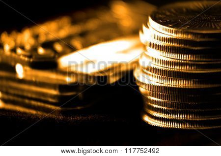Pile of old coins and bullion with dark background 