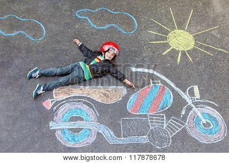 Little kid boy in helmet with motorcycle chalk picture