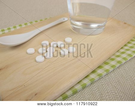 Schuessler salts tablets and glass of water
