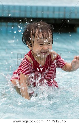 Chinese Little Girl Playing In Water