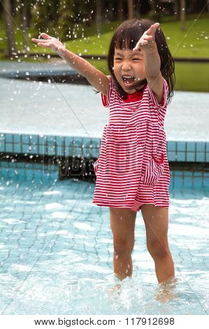 Chinese Little Girl Playing In Water