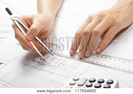Architect working on blueprint. Architects workplace - architectural project, blueprints, ruler, cal