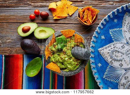 Guacamole with nachos avocado in Mexican molcajete and Sombrero hat