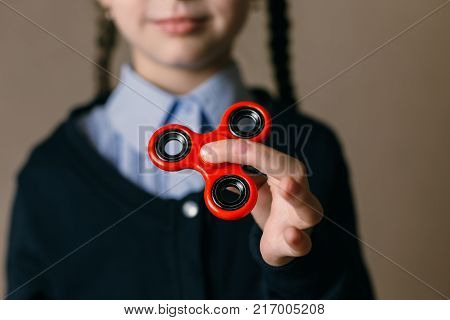 Little girl playing with a fidget spinner