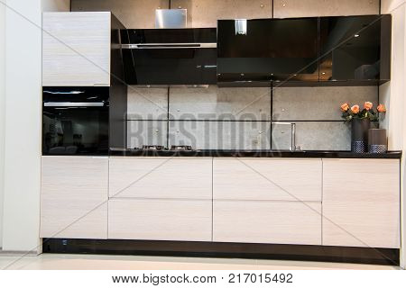 front view of modern kitchen interior with flowers in vase