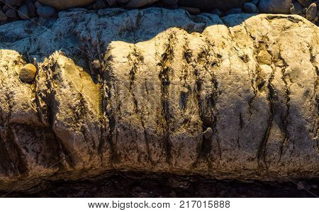 boulders and colorful pebbles on the beach on a warm summer day