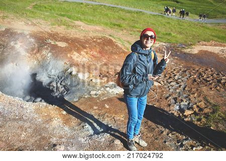 woman traveler on a walk in the Valley of the river of Hveragerdi Iceland. Hiking Tour of Reykjadalur Hot Springs