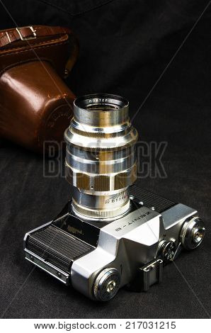 DONETSK, UKRAINE - May 07, 2016: old soviet film SLR camera Zenit - B with lens Jupiter-11, for use with 35 mm film, made in USSR in 1968 - 1973, manufactured by KMZ, with original leather case