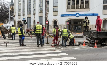 DEBRECEN, HUNGARY - DECEMBER 01, 2017: Workers on a road construction, industry and teamwork