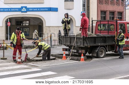 DEBRECEN, HUNGARY - DECEMBER 01, 2017: Workers on a road construction, industry and teamwork