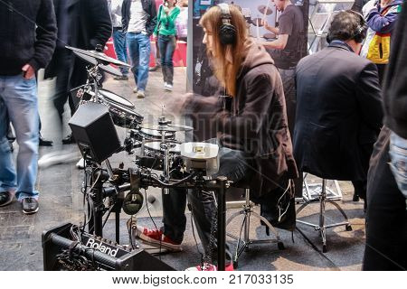 HANNOVER, GERMANY - MARCH 3, 2010: Amateur drummers play on Roland drums set in V-Drums Fun Park area at CeBIT trade show in Hannover, Germany on March 3, 2010.