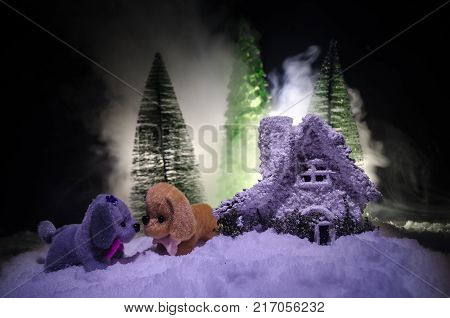 Toy Dog - A Symbol Of The New Year Under The Snow Against The Background Of Fir Branches. Toy's Dog 