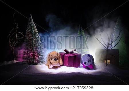 Toy Dog - A Symbol Of The New Year Under The Snow Against The Background Of Fir Branches. Toy's Dog 