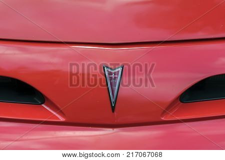 MOSCOW, RUSSIA - AUGUST 26, 2017: Close-up of Pontiac front emblem on red vintage car. Hood ornament . Retro car show exhibion, motor vehicles festival