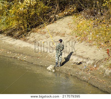 Fishermen On The Bank Of The River In Autumn. Fishing The Bait.
