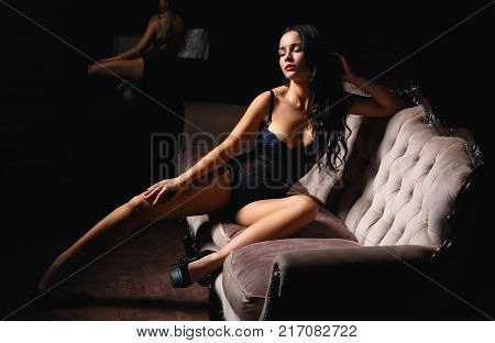Young girl in a sexy lingerie on the sofa