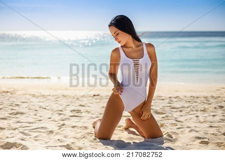 Perfect young girl in a sexy swimsuit in tropical island