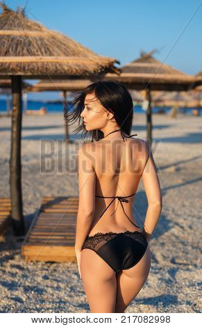 Beautiful young girl in a sexy black swimsuit