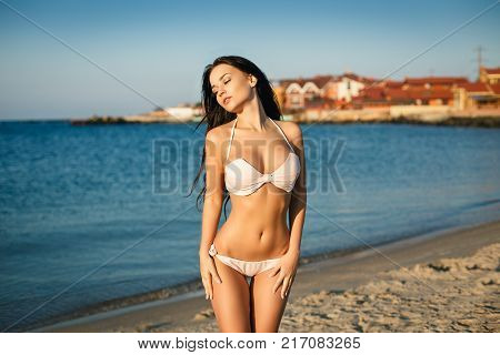 Beautiful young girl in a sexy pink swimsuit